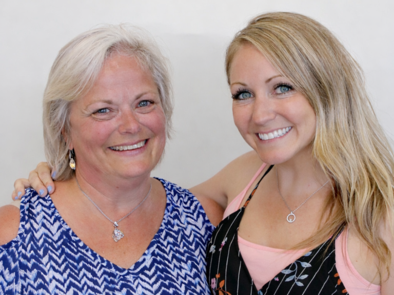 Portrait of two smiling female clinic professionals standing together on the Bowmanville Family Physiotherapy team page.